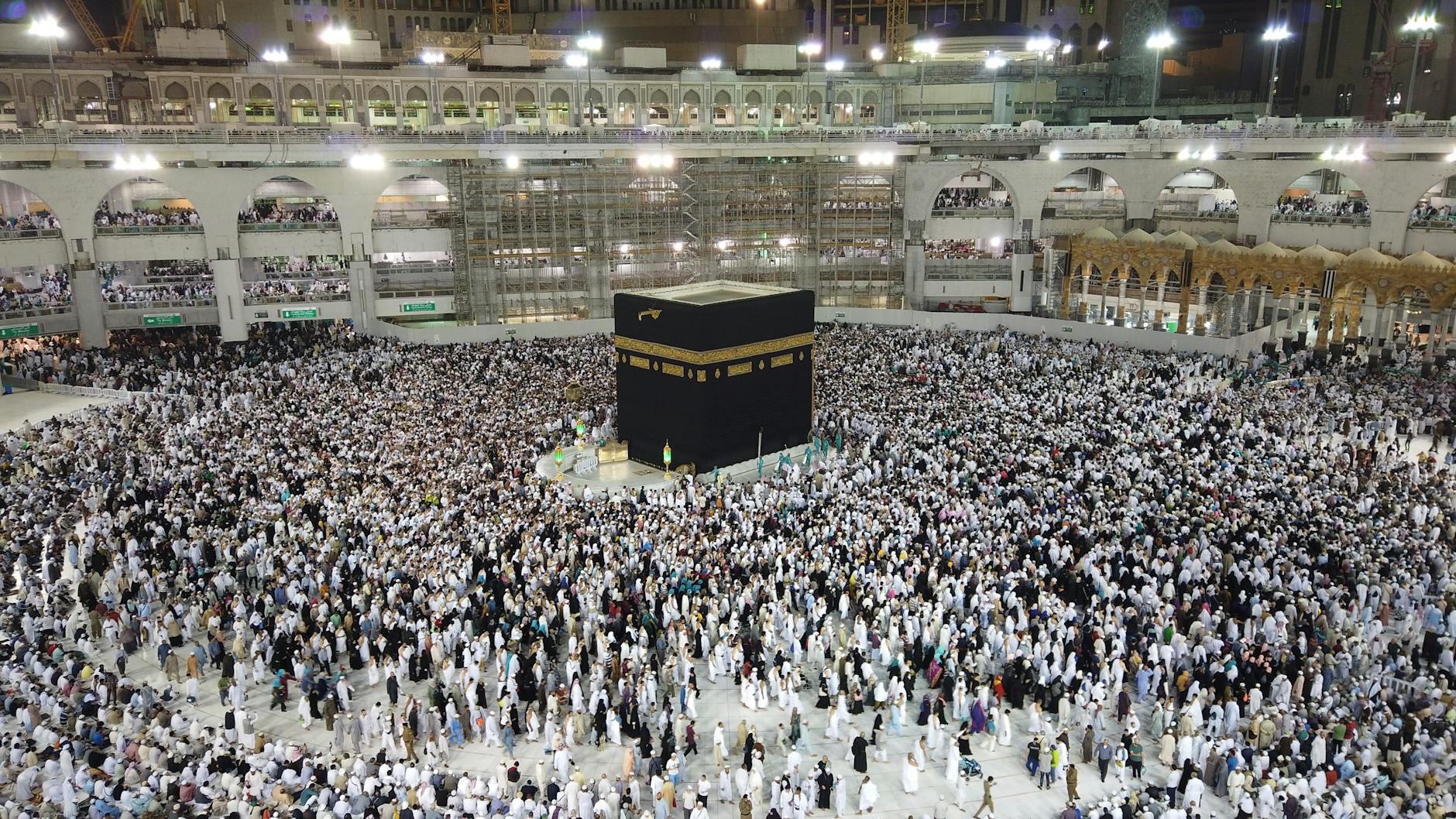 a group of people standing near the kaaba